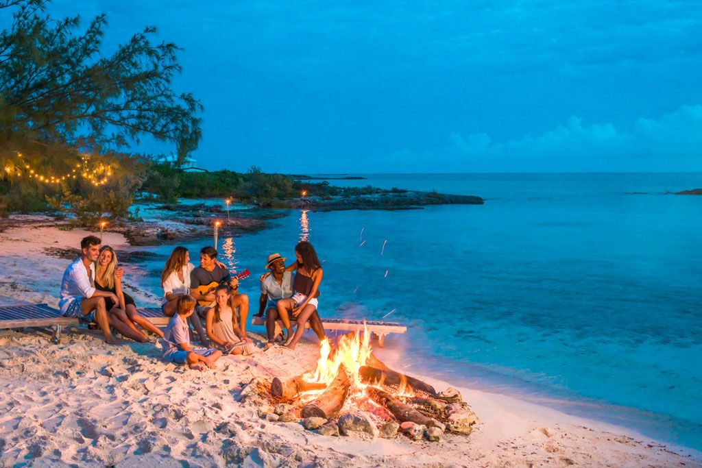 Rock Legend Lenny Kravitz Invites Travelers To The Bahamas 3 bahamas friends group on the beach