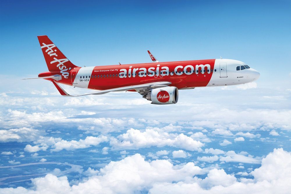 AirAsia plane over the clouds AirAsia Airbus A320