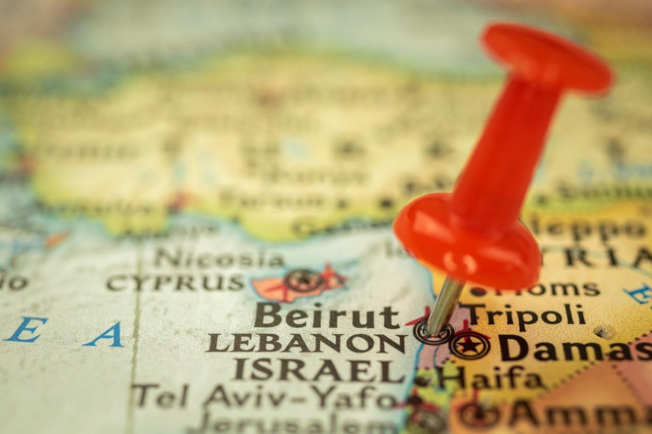 A close-up of a map focusing on the eastern Mediterranean region, specifically highlighting Beirut, Lebanon, with a red pushpin marking the city’s location. Surrounding cities and countries like Cyprus, Israel, Damascus in Syria, and the Mediterranean Sea are also visible.