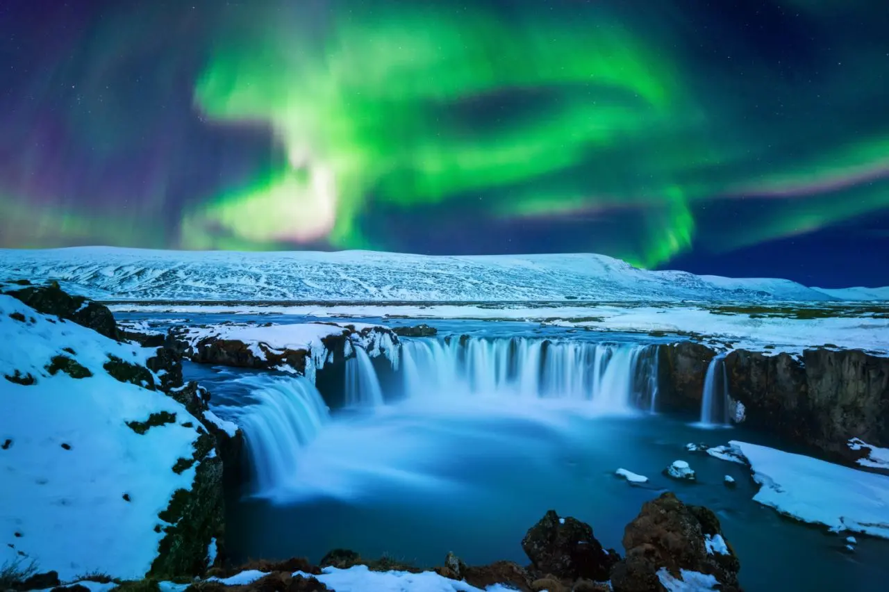 Aurora Borealis and Godafoss Waterfall in winter in Iceland