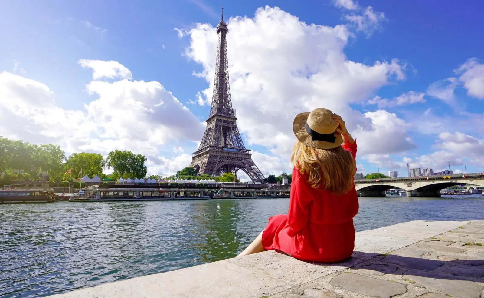 woman tourist watching Eiffel Tower in Paris on the banks of Seine River
