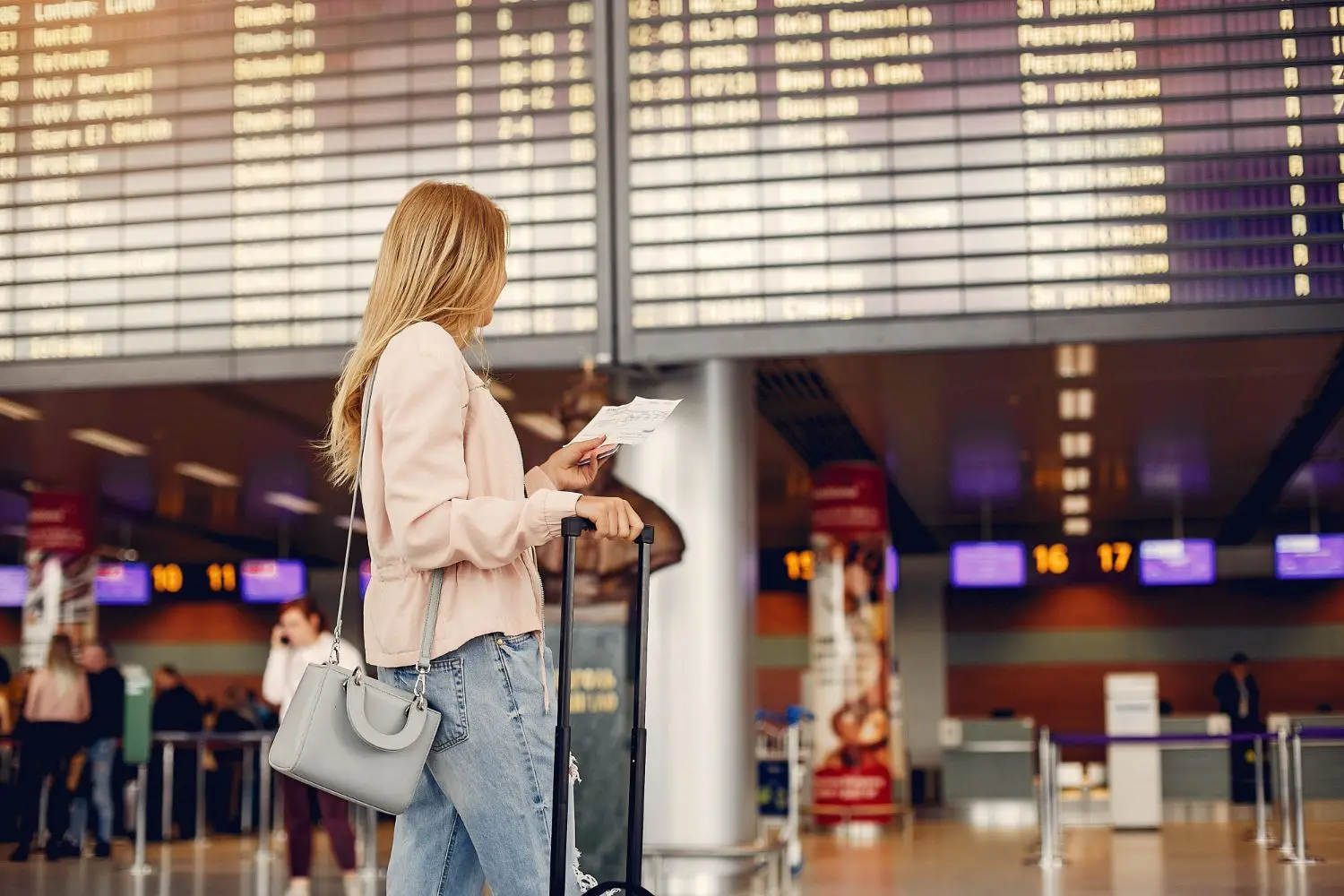 woman traveler checking flight time at airport
