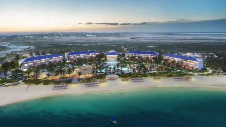 Luxury Travel 21 Aerial sunset view of Salterra, A Luxury Collection Resort & Spa, in South Caicos, showcasing beachfront villas, pools, and lush tropical surroundings.