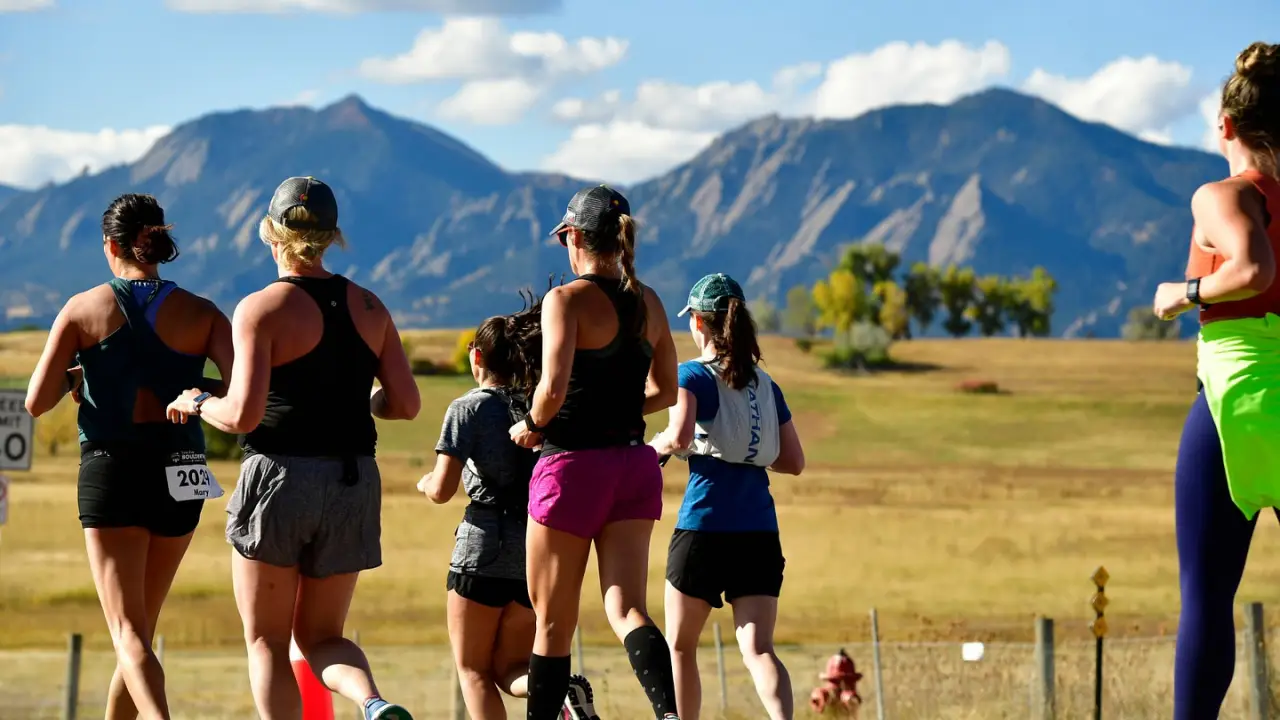 Runners competing at Boulderthon marathon with great scenery.