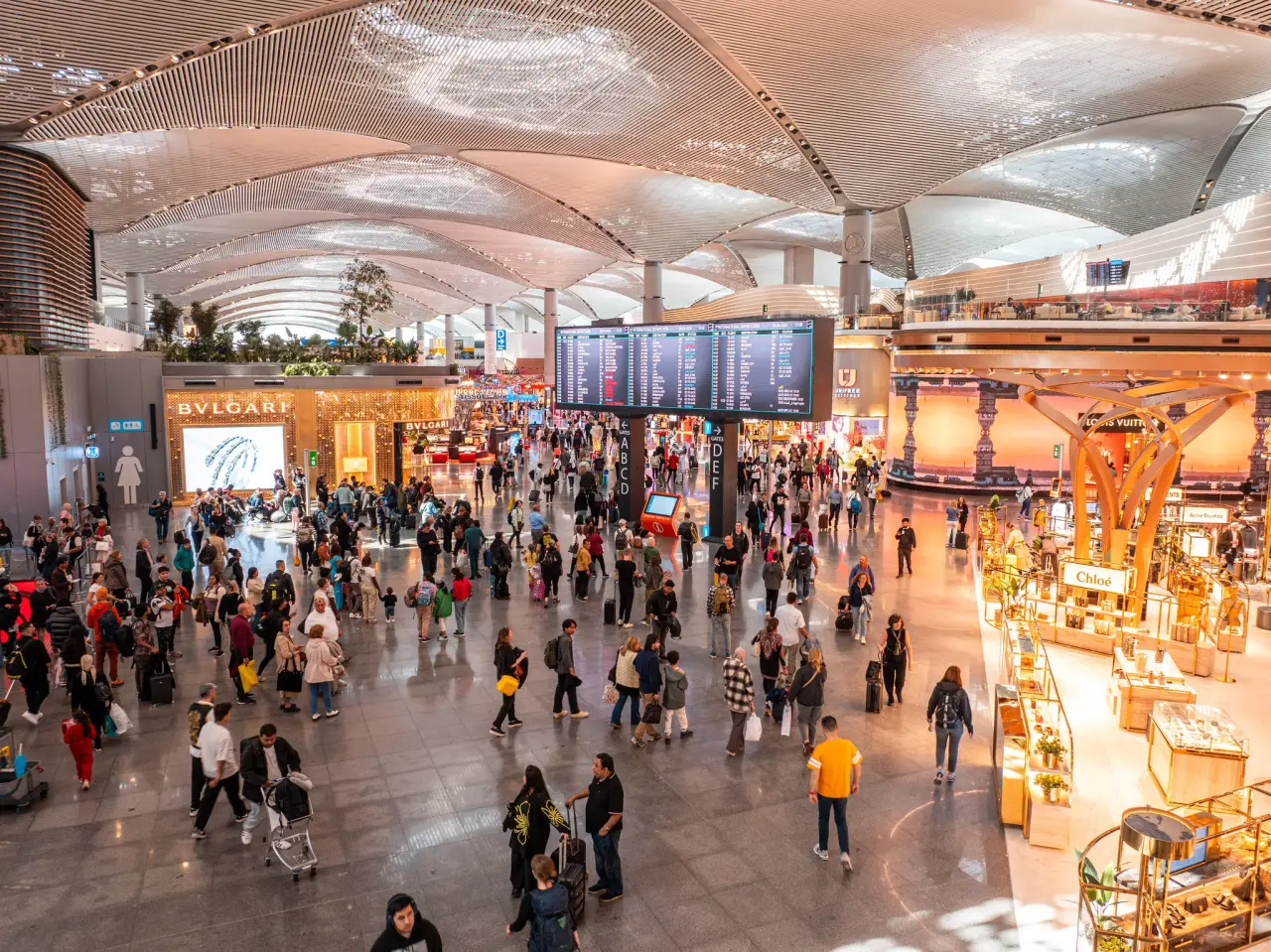 Travelers passing through the duty free stores at Istanbul Airport. Luxury brands like Bvlagari and Chloe can be seen