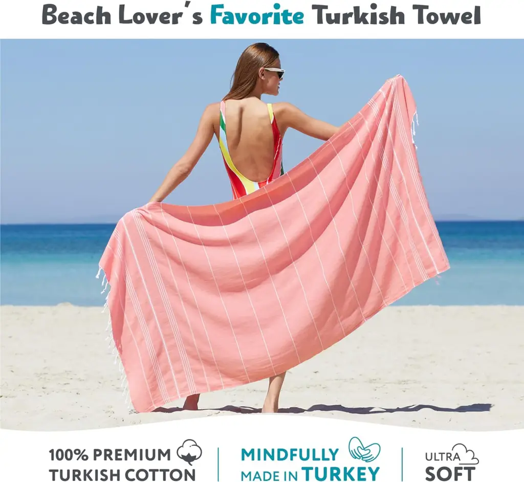 10 Must-Have Beach Essentials From Amazon For A Perfect Summer Day 4 Woman dries her body with a pink 100% cotton Made in Turkey beach towel on the beach