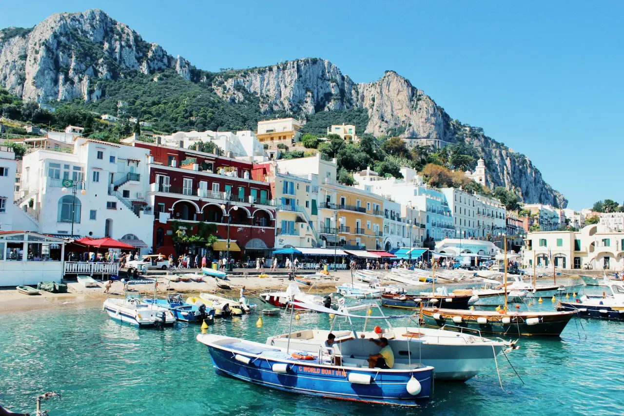 Harbour at Capri Island. Bold colours of turquoise seas and contrasting boats and buildings galore.