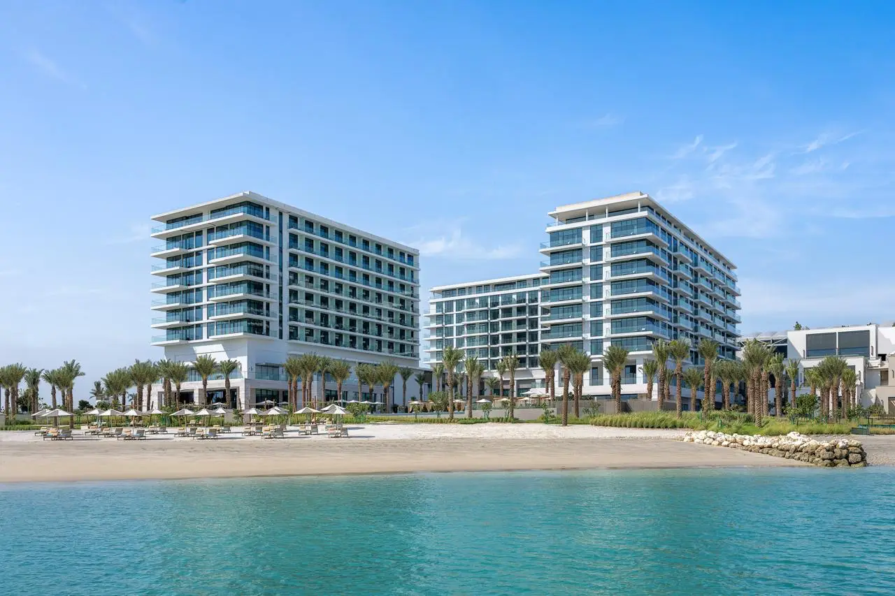 three buildings and beach and sea represents Address Beach Resort Bahrain