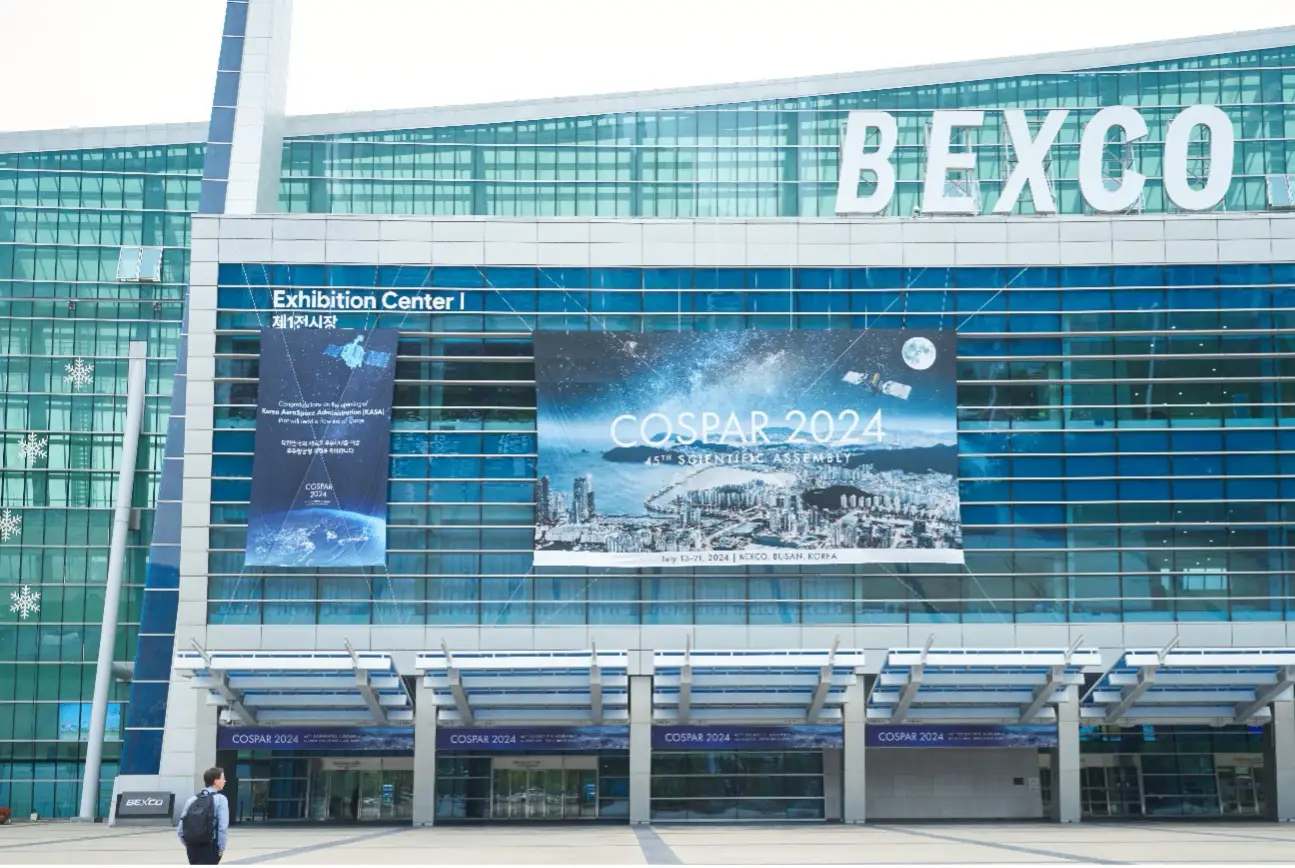 Busan's BEXCO exterior with COSPAR 2024 poster