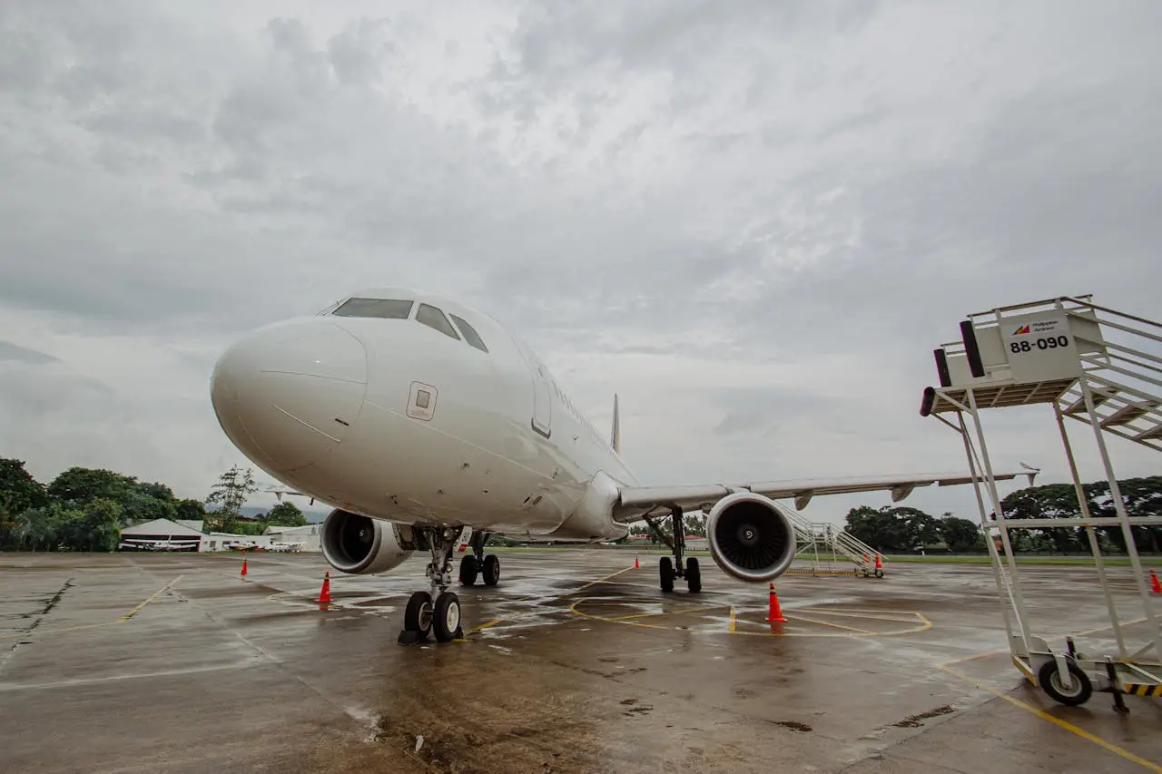 a parked aircraft and an airstair nearby