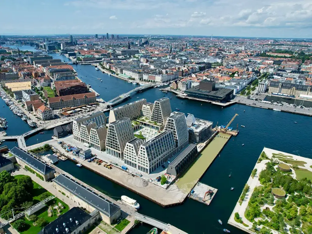 Aerial view of Copenhagen’s Paper Island, featuring the 25hours Hotel Paper Island with its unique architecture, surrounded by water and cityscape.