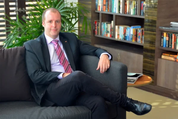 Koen Vermeersch, Ascott Thonglor Bangkok Area General Manager, seated in a modern office setting.