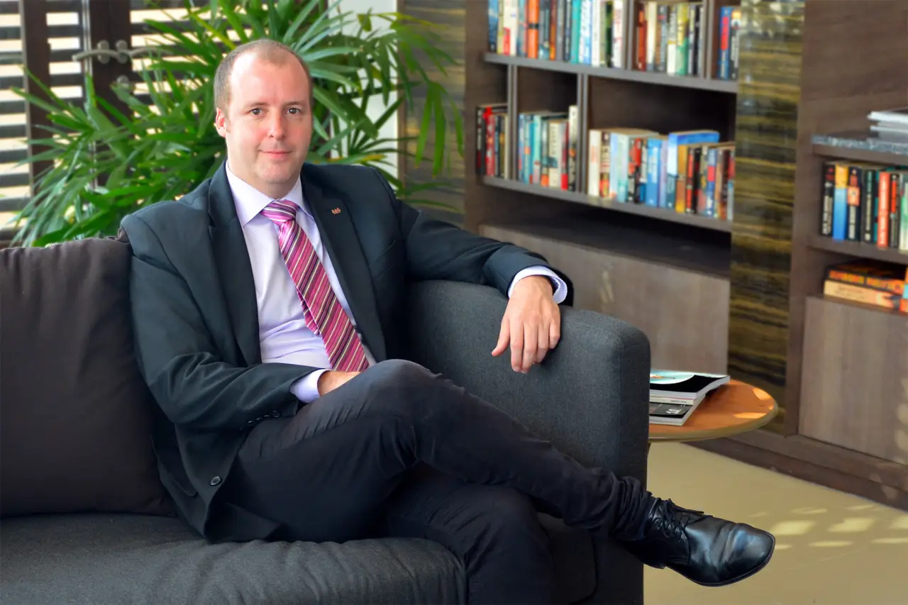 Koen Vermeersch, Ascott Thonglor Bangkok Area General Manager, seated in a modern office setting.