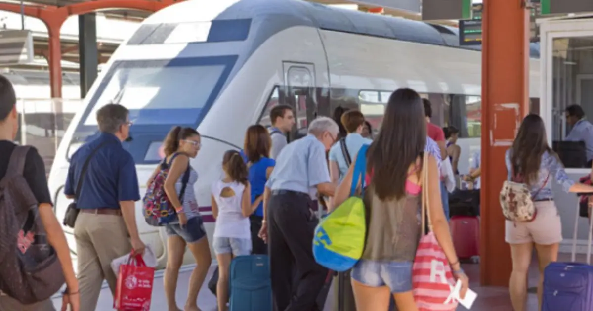 Passengers boarding a Renfe high-speed train at a station in Spain.