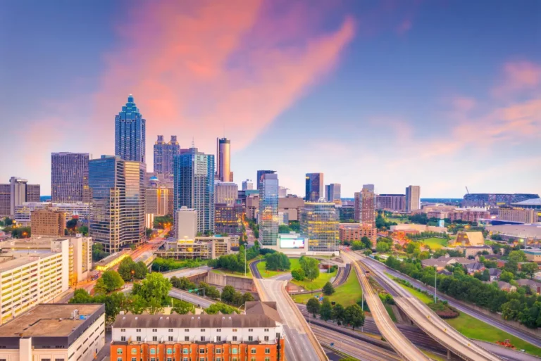 Hotel Openings 132 Scenic view of the Atlanta skyline at sunset, showcasing modern skyscrapers and city streets