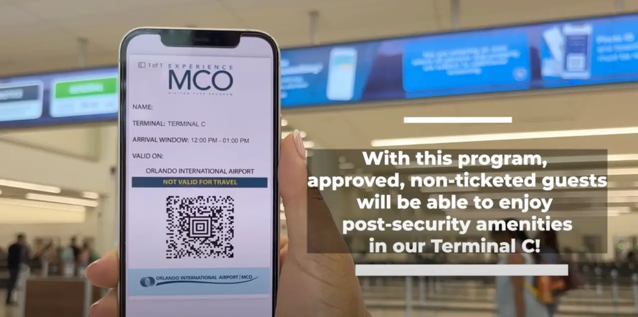 A smartphone displaying an Experience MCO Visitor Pass, allowing non-ticketed guests access to Terminal C at Orlando Airport.