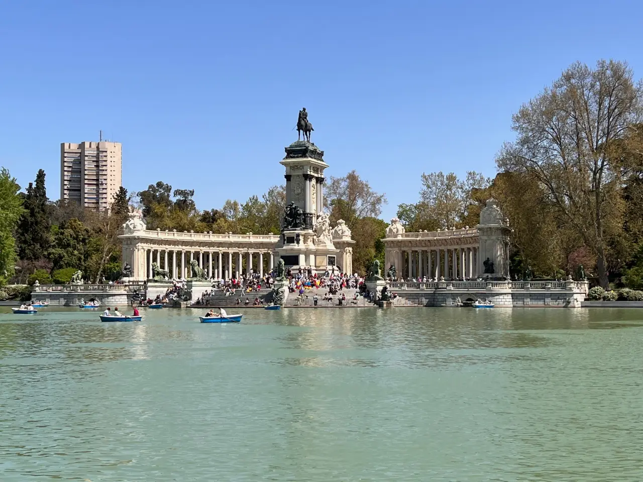 Monument to Alfonso XII at El Retiro Park in Madrid, Spain, with a lake in the foreground.