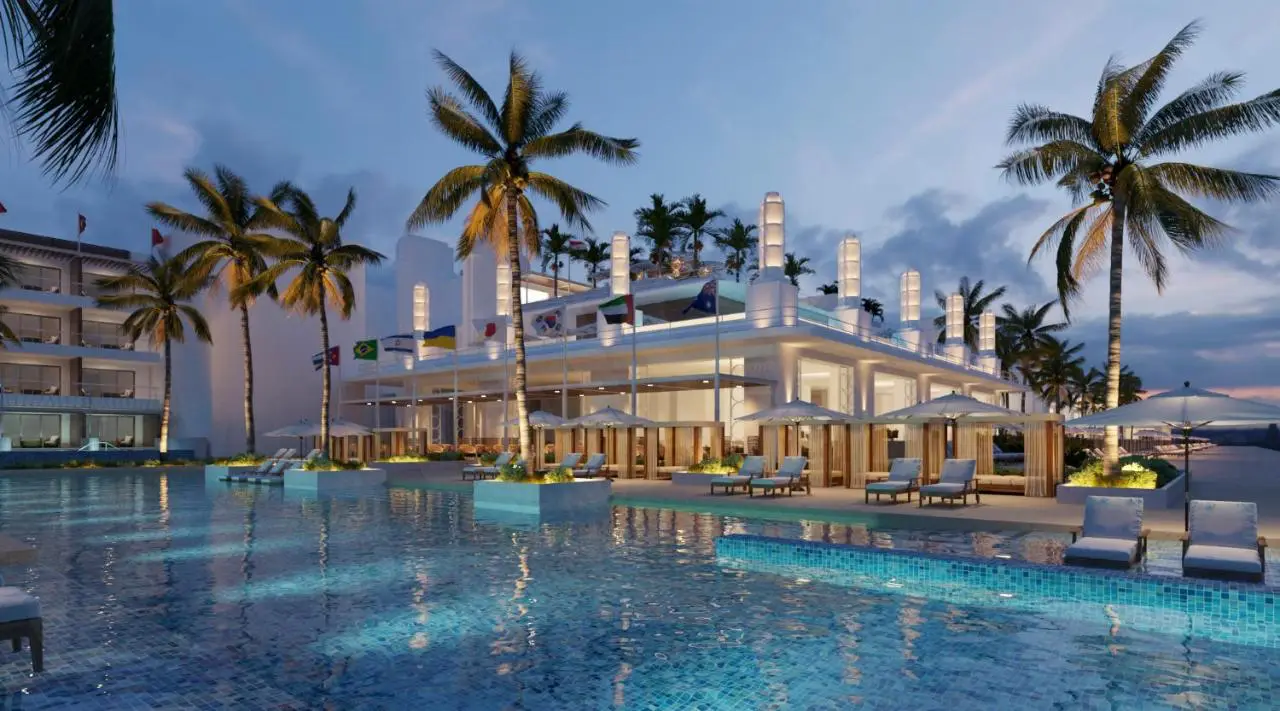 Night view of Princess Senses The Mangrove resort featuring a well-lit pool area, modern architecture, and swaying palm trees.