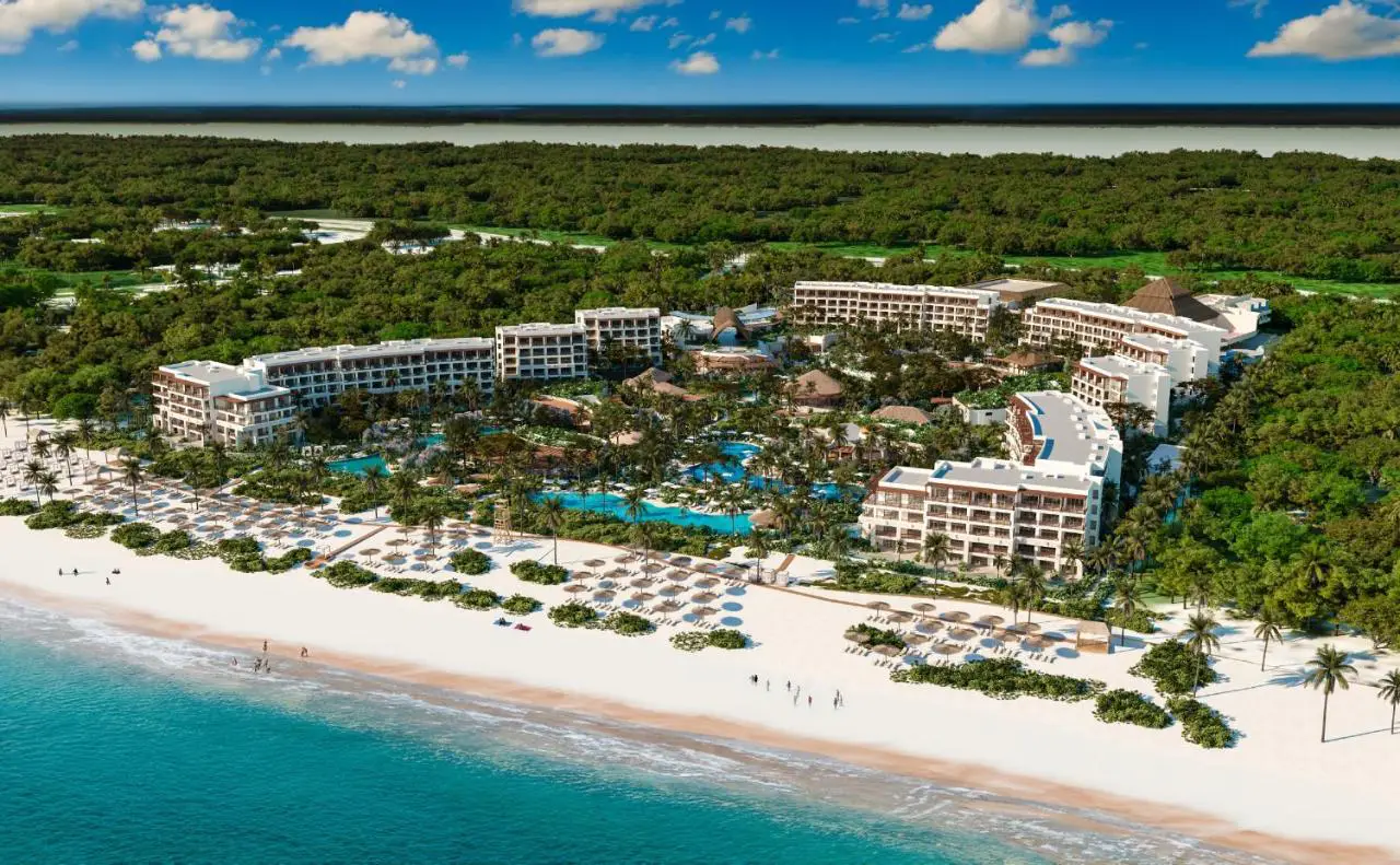 Aerial view of Secrets Playa Blanca Costa Mujeres resort featuring lush tropical surroundings, expansive pools, and a pristine white-sand beach.