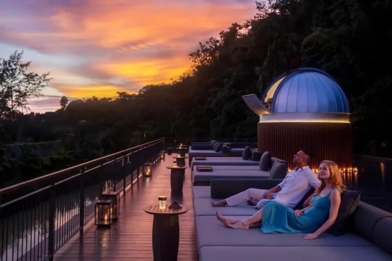 Couple stargazing at sunset on a rooftop lounge at Anantara Layan Phuket.