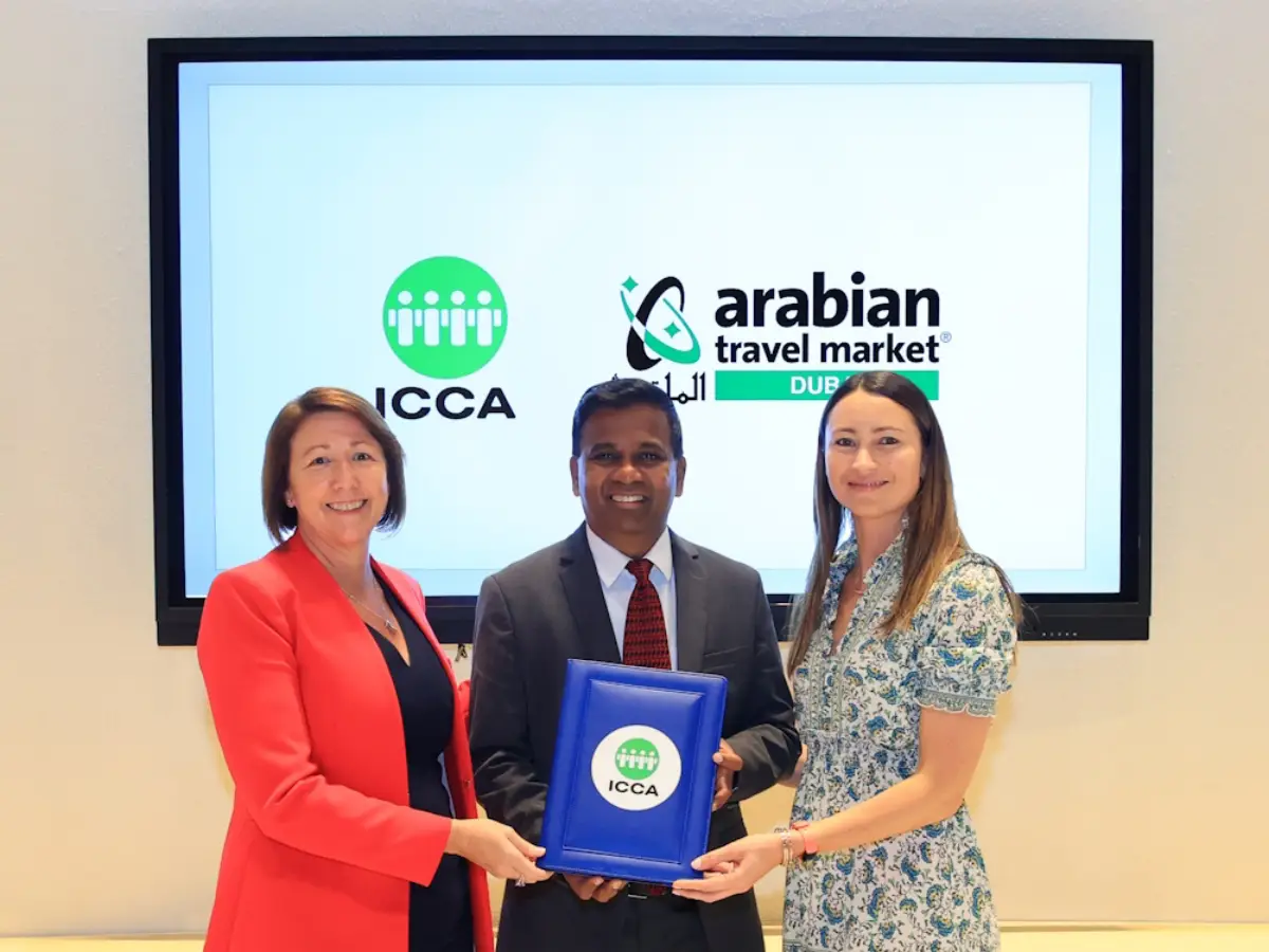 Atm Partners With Icca 4 Three representatives from ICCA and Arabian Travel Market pose together after announcing a new partnership, holding a commemorative plaque.