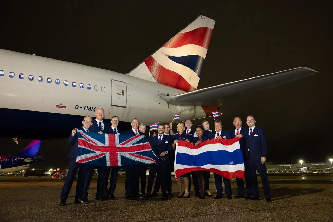 British Airways crew celebrating the return to Bangkok with UK and Thai flags.