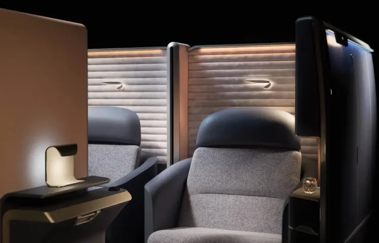 Luxury Travel 29 British Airways’ new First Class seat showcasing luxurious design and privacy, featuring curved walls, soft panelling, and elegant ambient lighting.