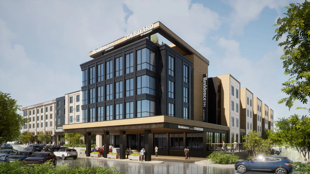 Two Hotels, One Location: The Marriott Center In Brookfield, Wisconsin 14 A modern dual-branded Marriott Center featuring the Residence Inn and Courtyard by Marriott in Brookfield, Wisconsin. The building has sleek black and beige architecture with large glass windows and a rooftop patio.