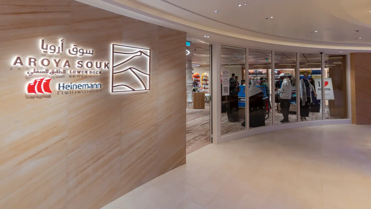 Entrance to Aroya Souk boutique on AROYA cruise ship, featuring Heinemann branding and a glimpse of the shop interior.