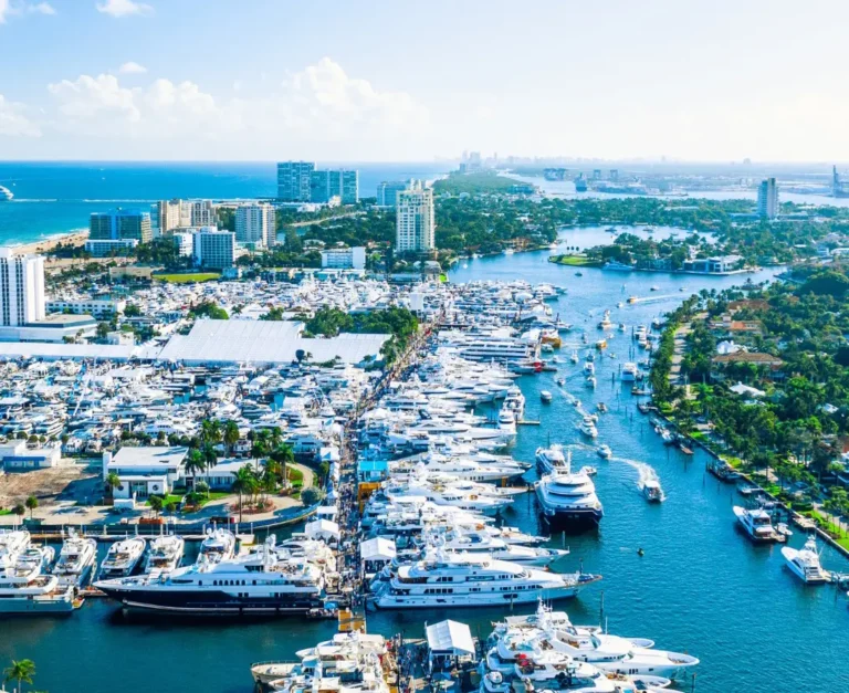 Luxury Travel 23 Aerial view of Fort Lauderdale’s marina with luxury yachts, waterways, and city skyline under clear blue skies.