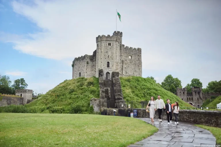 Family walking towards Cardiff Castle, a historic landmark in Wales.