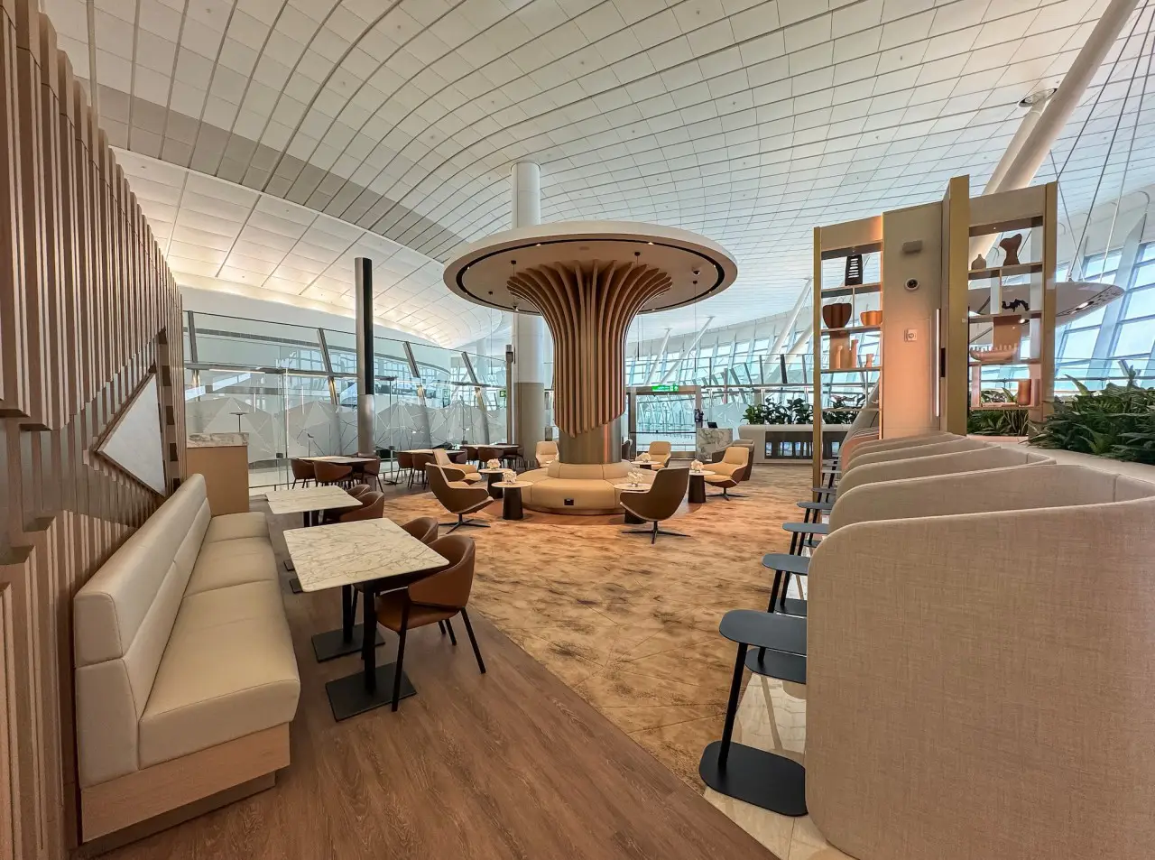 Interior of Etihad’s U.S. Preclearance Lounge at Zayed International Airport, showcasing modern seating, elegant design, and a tranquil atmosphere.