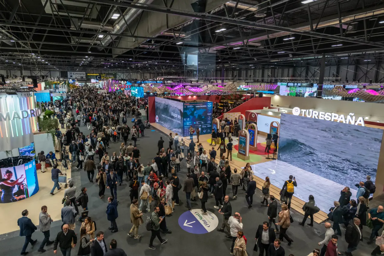 A bustling crowd at FITUR 2025 in Madrid, showcasing vibrant exhibition stands and global tourism participants.