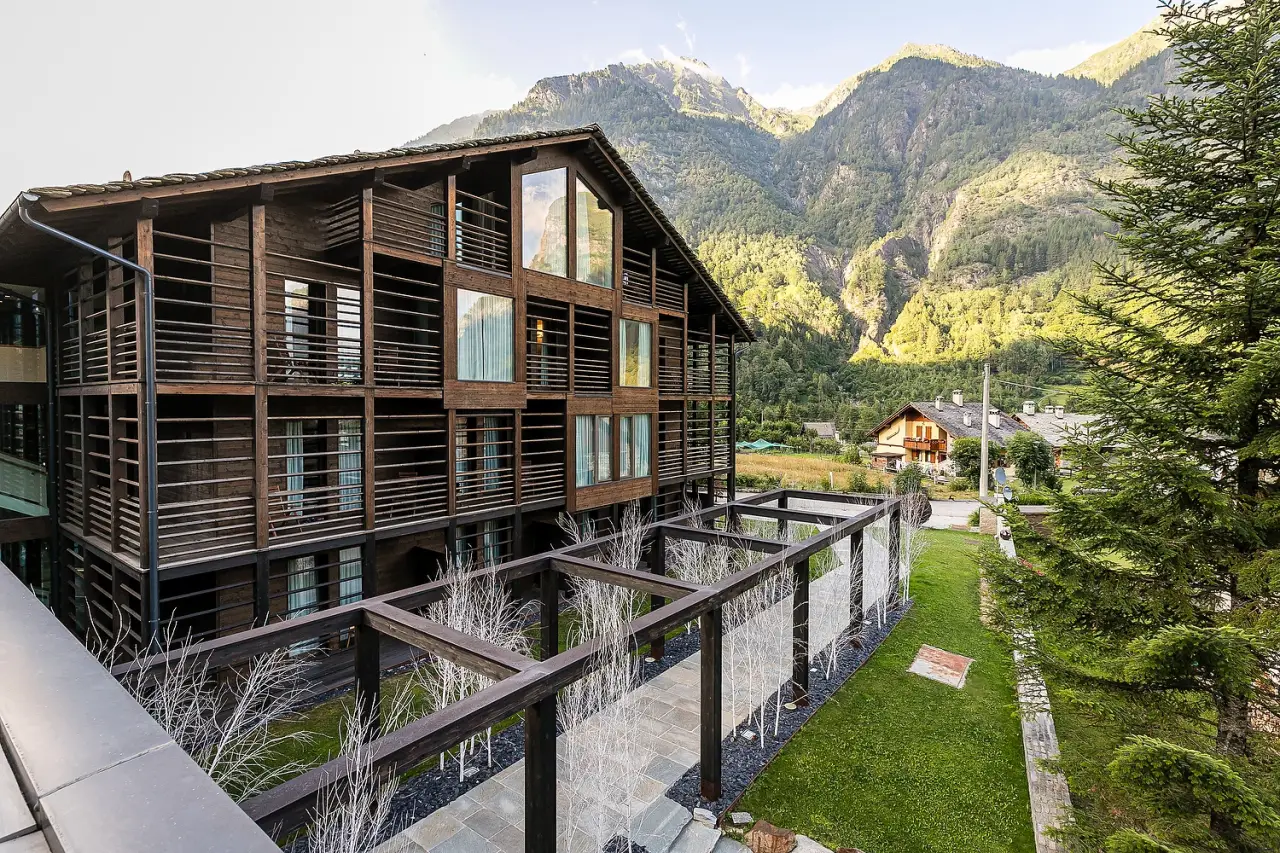 Nh Collection Alagna Mirtillo Rosso Joins Minor Hotels In The Italian Alps 8 Exterior view of NH Collection Alagna Mirtillo Rosso hotel with a backdrop of the Italian Alps.