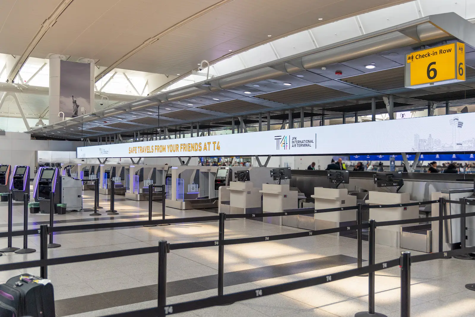 Check-in area at JFK International Airport Terminal 4 with empty counters.