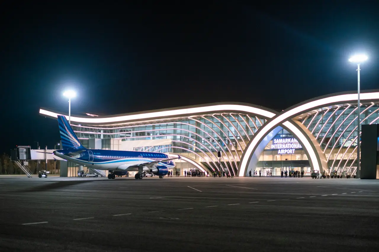 Fly Nonstop From Samarkand To Baku &Amp; Krasnoyarsk 3 Azerbaijan Airlines aircraft parked at night in front of the modern terminal of Samarkand International Airport.