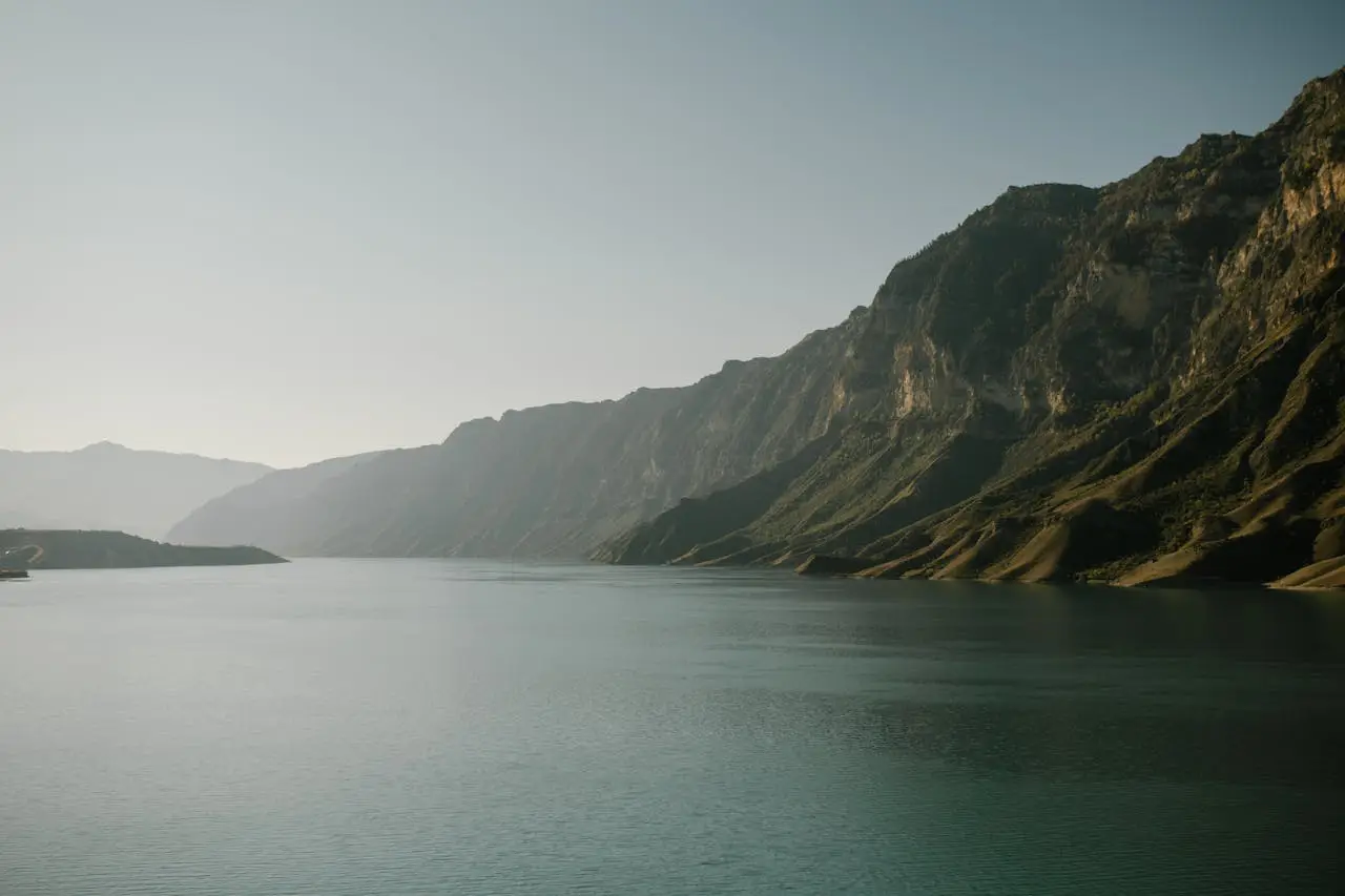 What Is Adventure Travel: A Guide For A Great Vacation 2 Adventure travel destination featuring a serene lake surrounded by towering mountains under a clear sky.
