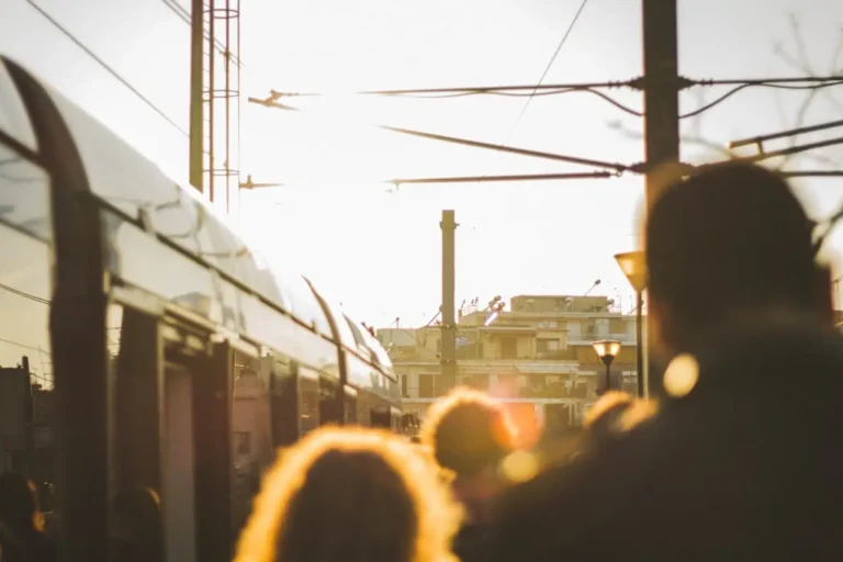 Commuters waiting for a train in Athens during sunset.