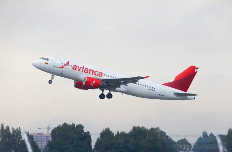 An Avianca Airbus A320 aircraft taking off against a cloudy sky, featuring the airline’s red and white livery.