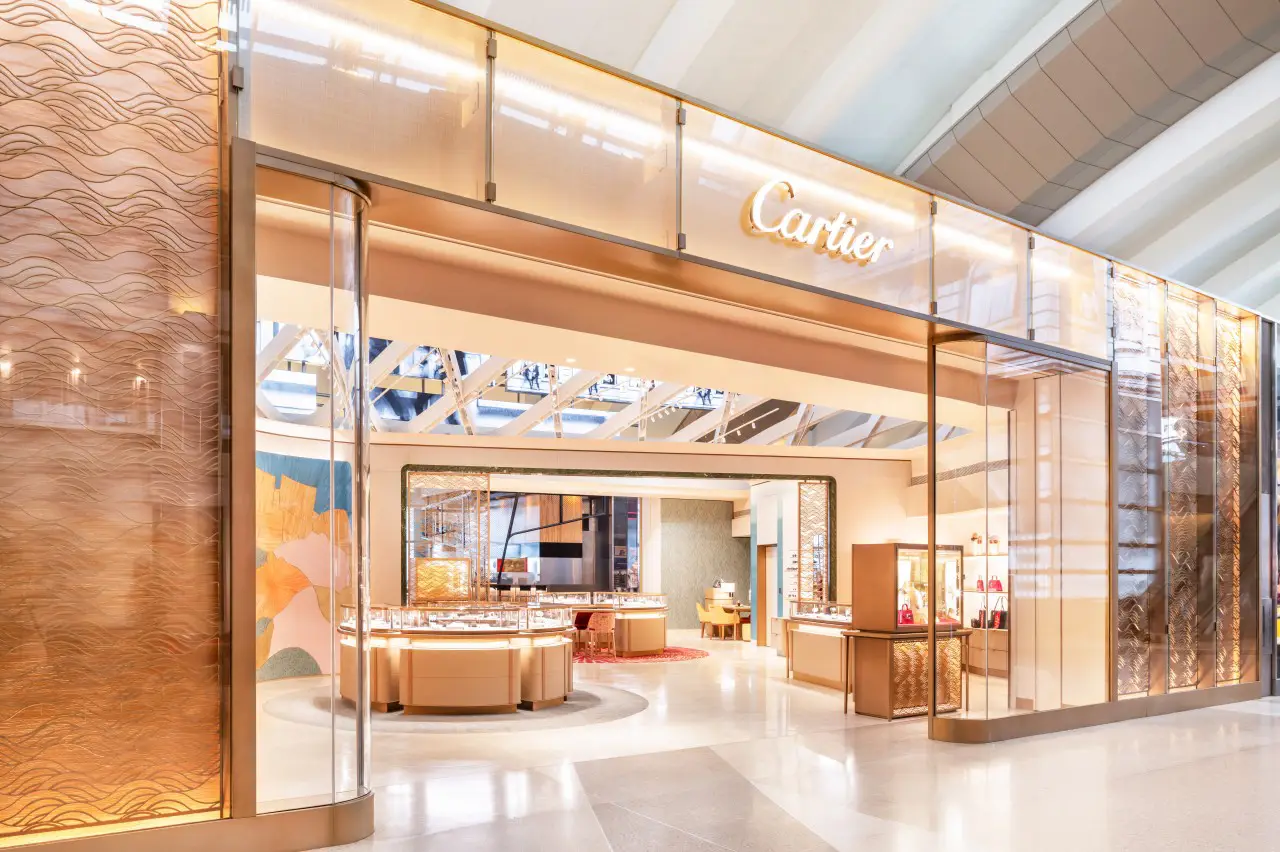 Cartier’s new boutique at LAX airport featuring luxurious interior design and display cases.