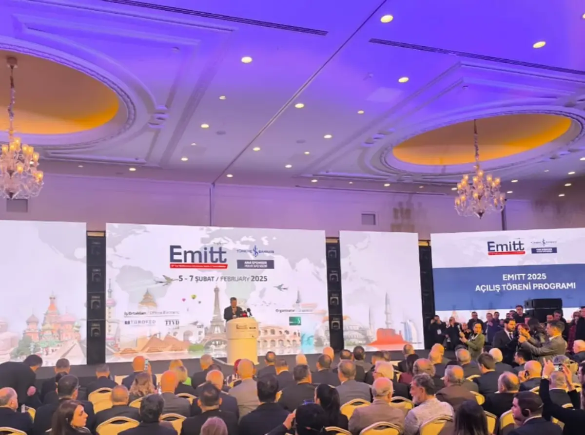 Emitt 2025 Kicks Off In Istanbul With Global Tourism Leaders 2 A large audience attends the opening ceremony of EMITT 2025, with a speaker addressing the crowd from a stage featuring event banners and global tourism visuals.