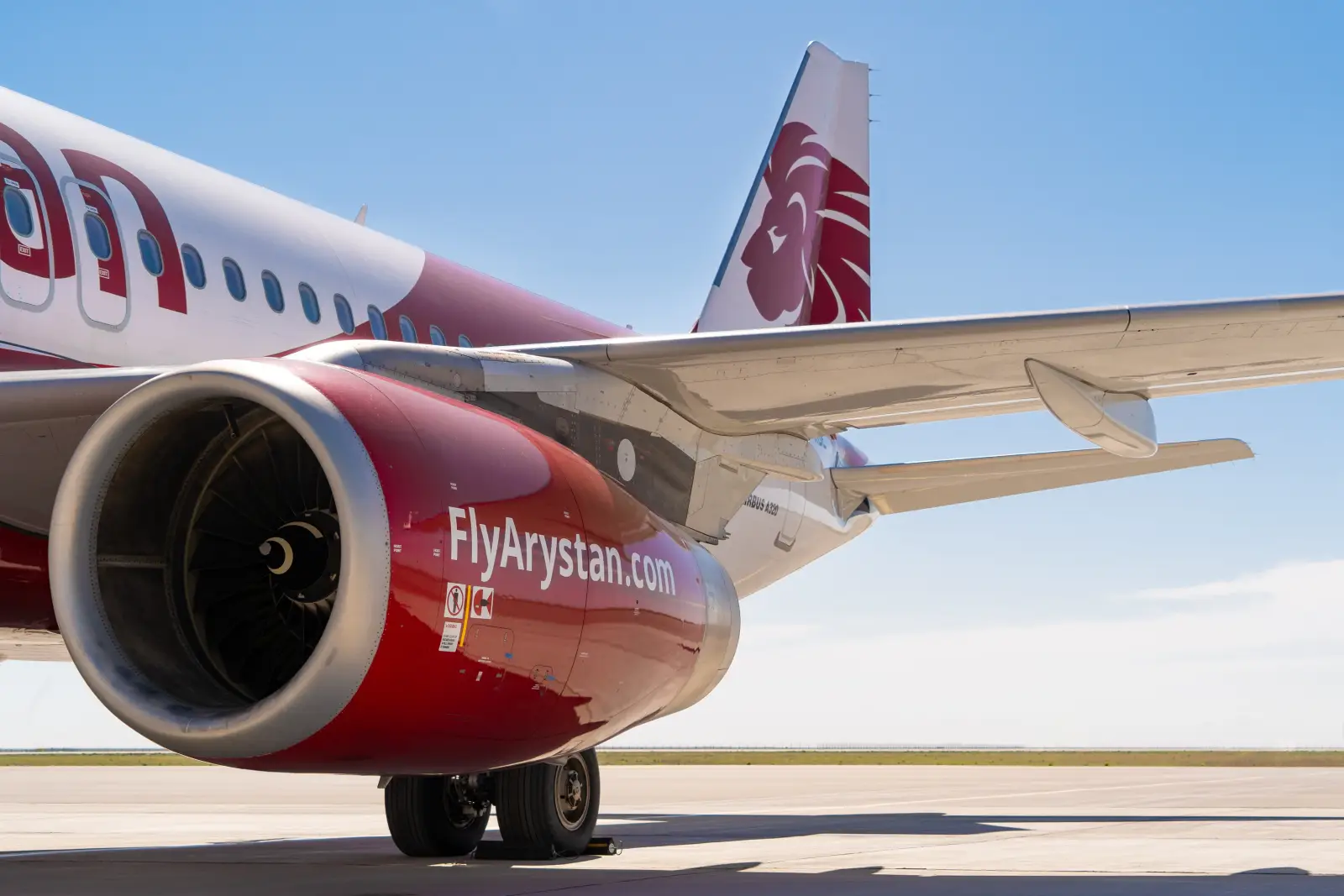 A FlyArystan Airbus A320 on the tarmac, featuring the airline’s red and white branding, promoting its new Istanbul-Karaganda flights.