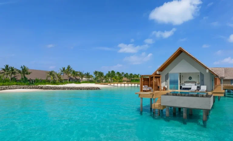 Overwater pool villa at JW Marriott Kaafu Atoll Island Resort, Maldives, featuring a private infinity pool, sun loungers, and direct lagoon access.