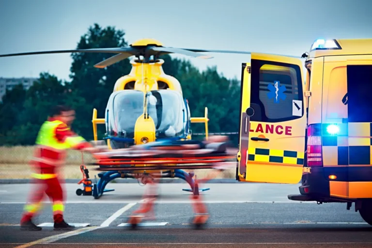 Emergency medical team transferring a patient from a helicopter to an ambulance.