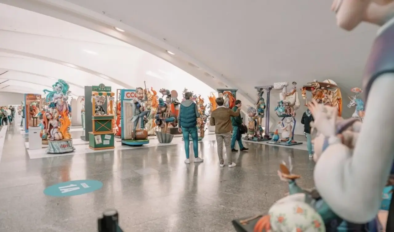 Visitors admire colorful ninots at the Ninot Exhibition 2025 in Valencia.