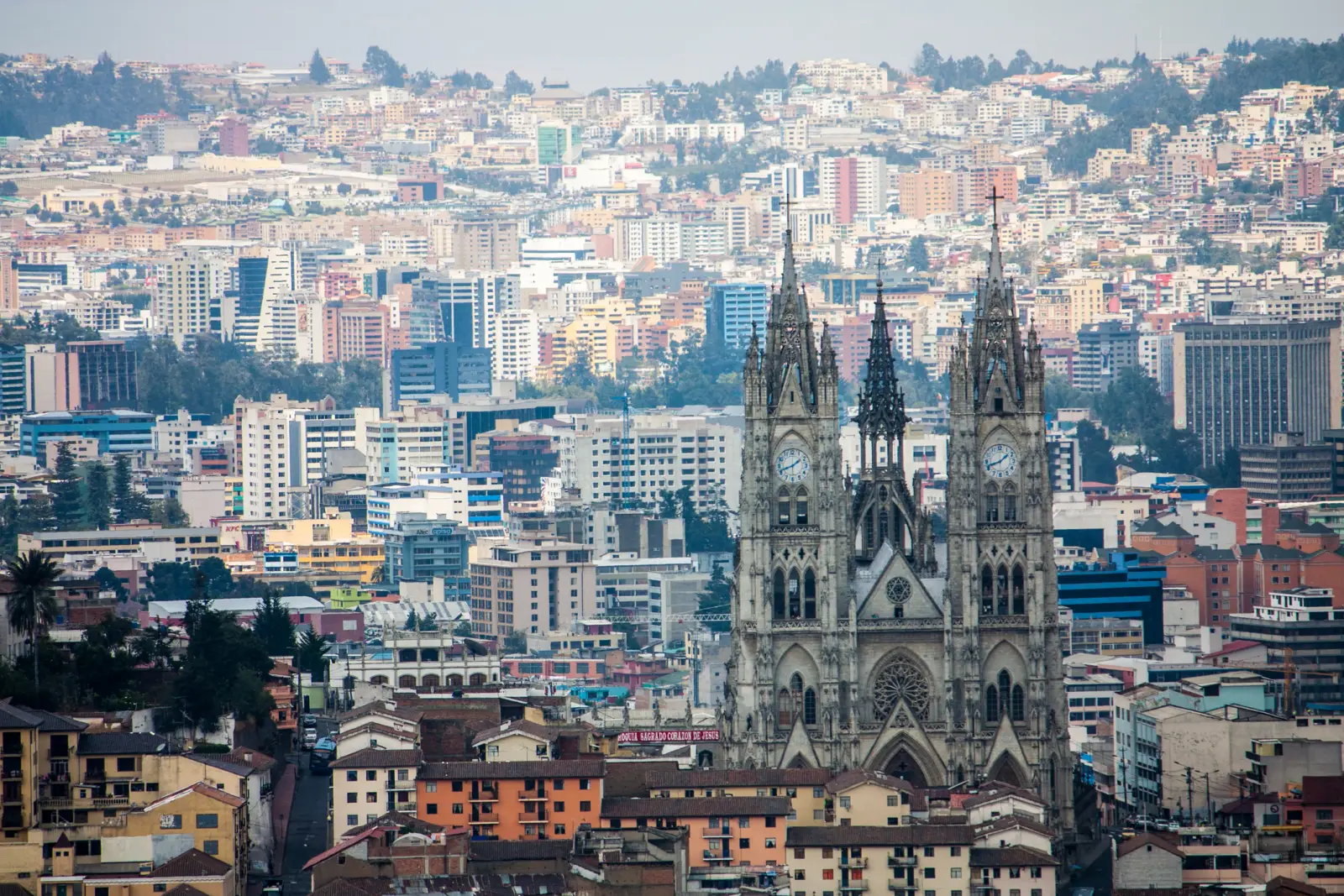Tourism In Ecuador Drops By 12.6% Amid Rising Violence And Instability 2 A panoramic view of Quito, Ecuador, featuring the Basilica del Voto Nacional with the city’s modern and historic buildings in the background.