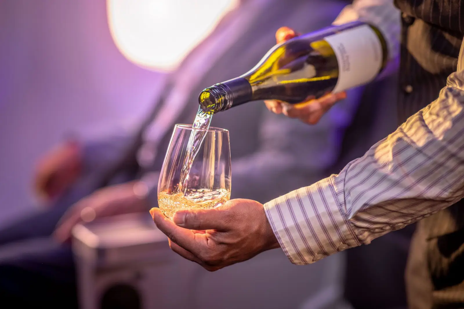 A flight attendant pours a glass of Air New Zealand’s exclusive Thirteen Forty Five wine for a premium cabin passenger.