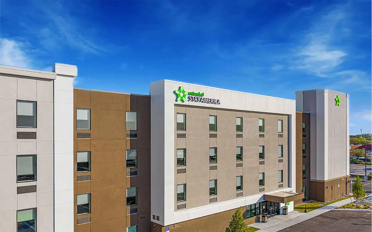 21 Brilliant New Hotels In Florida You’ll Want To Book In 2025 20 Exterior view of the newly built Extended Stay America Premier Suites Pensacola – NAS Corry Station under a clear blue sky.