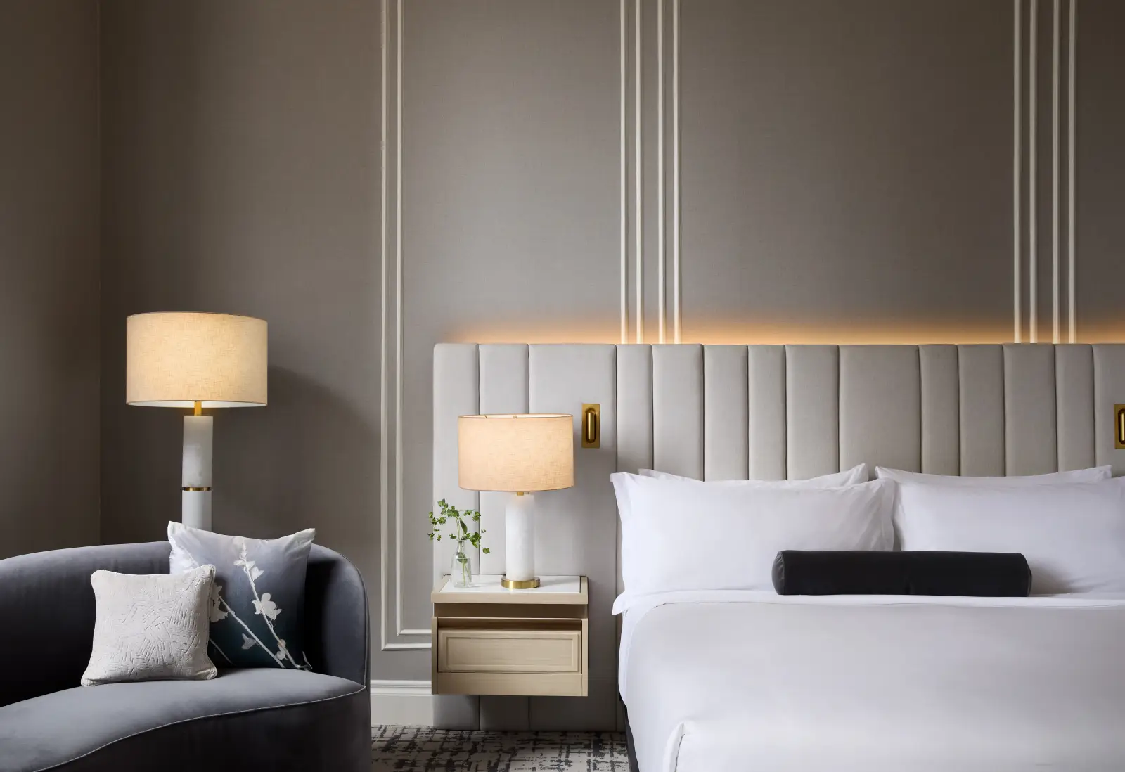 Luxurious guestroom at InterContinental Indianapolis featuring an elegant upholstered headboard, soft lighting, and sophisticated decor.