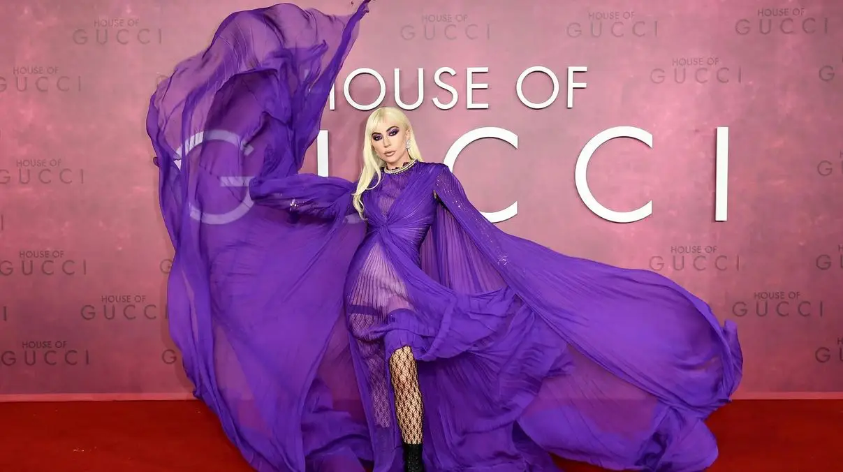 Lady Gaga To Perform Four Shows In Singapore, The Only Stop In Asia 2 Lady Gaga in a flowing purple gown at the House of Gucci premiere, posing dramatically on the red carpet.